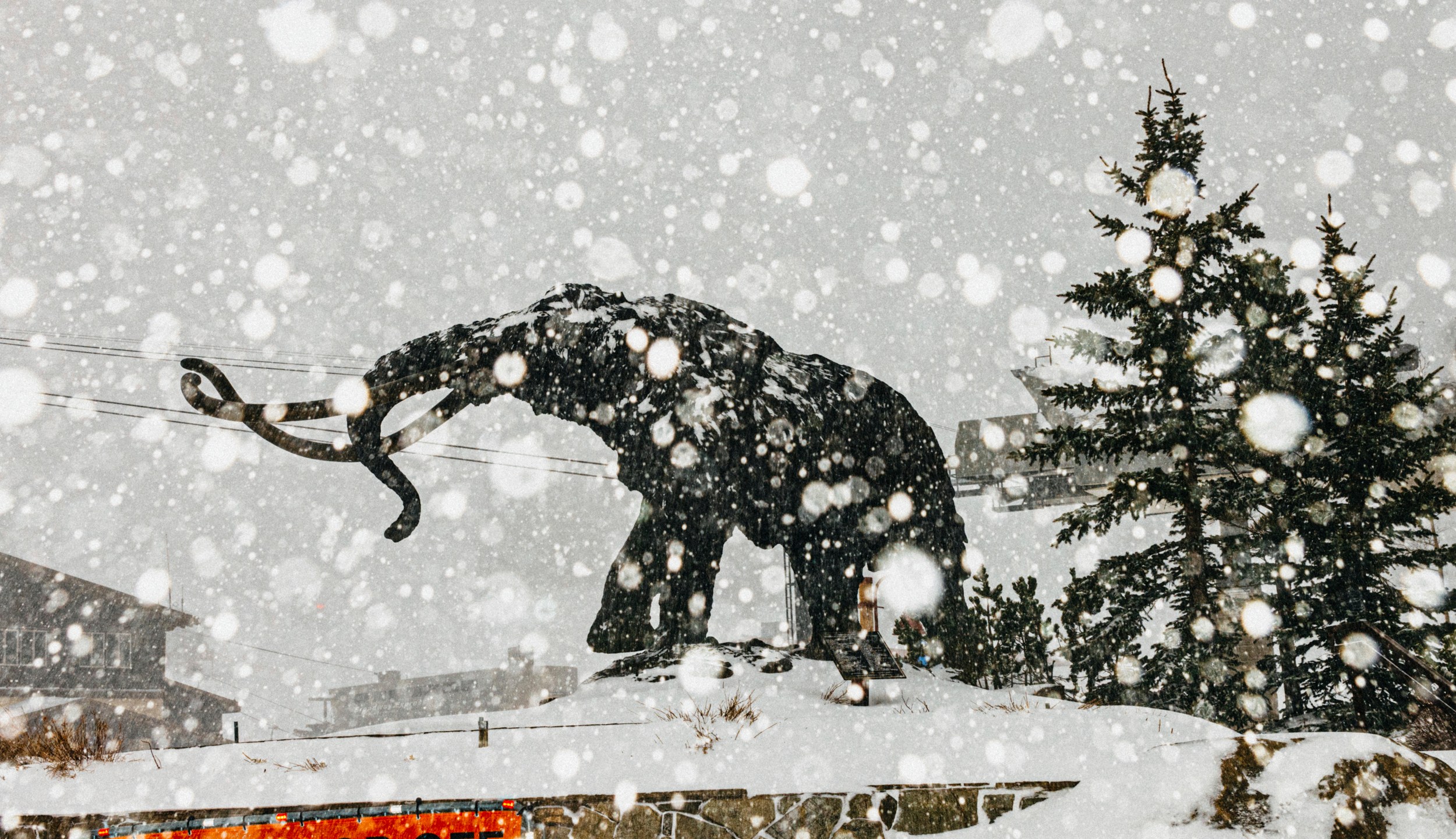 In this photo provided by Mammoth Mountain Ski Area, fresh snow falls in the guest drop-off area in Mammoth Mountain in Mammoth Lakes, Calif., on Friday, April 15, 2022. California storms have blanketed the Sierra Nevada in snow. Winter isn't quite ready to give up its grip on the Eastern Sierra. Mammoth Mountain is expecting a foot of fresh snow Saturday. (Peter Morning/MMSA via AP)