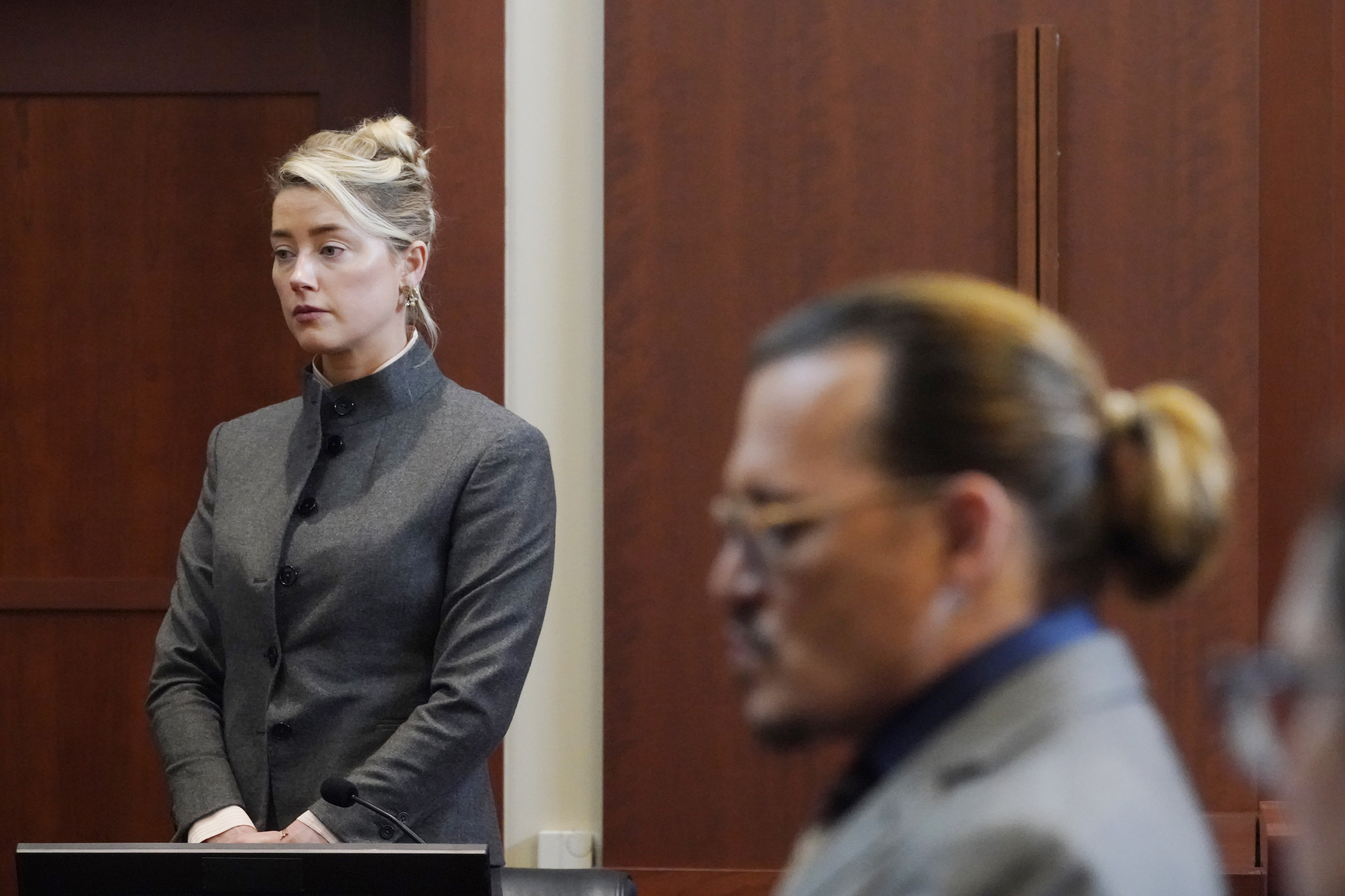 Actors Amber Heard and Johnny Depp watch as the jury leave the courtroom for a lunch break at the Fairfax County Circuit Courthouse in Fairfax, Va., Monday, May 16, 2022. Depp sued his ex-wife Heard for libel in Fairfax County Circuit Court after she wrote an op-ed piece in The Washington Post in 2018 referring to herself as a "public figure representing domestic abuse." (AP Photo/Steve Helber, Pool)