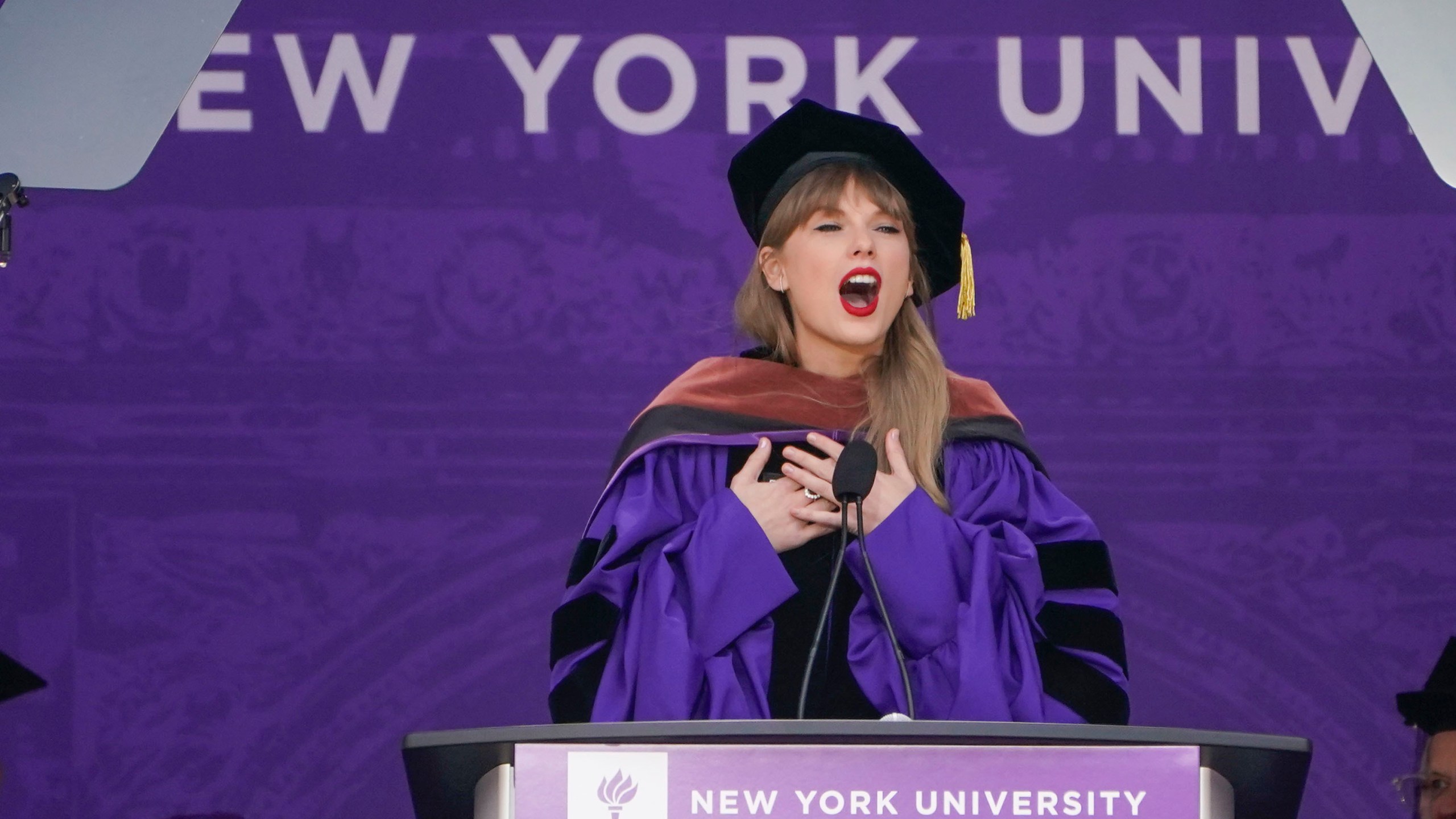 Taylor Swift speaks during a graduation ceremony for New York University at Yankee Stadium in New York, Wednesday, May 18, 2022. (AP Photo/Seth Wenig)