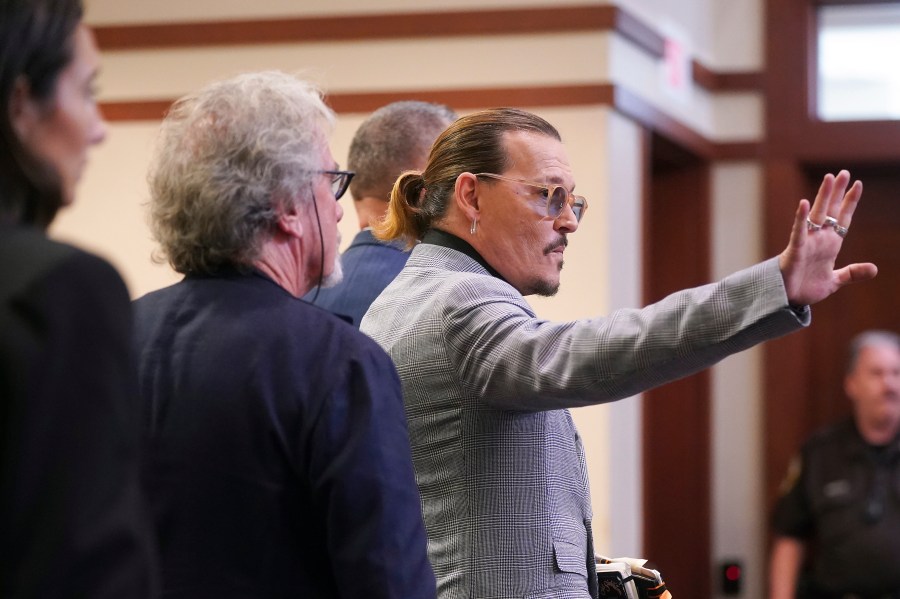 Actor Johnny Depp waves as he leaves the courtroom at the Fairfax County Circuit Courthouse in Fairfax, Va., Thursday, May 19, 2022. Actor Johnny Depp sued his ex-wife Amber Heard for libel in Fairfax County Circuit Court after she wrote an op-ed piece in The Washington Post in 2018 referring to herself as a "public figure representing domestic abuse." (Shawn Thew/Pool Photo via AP)