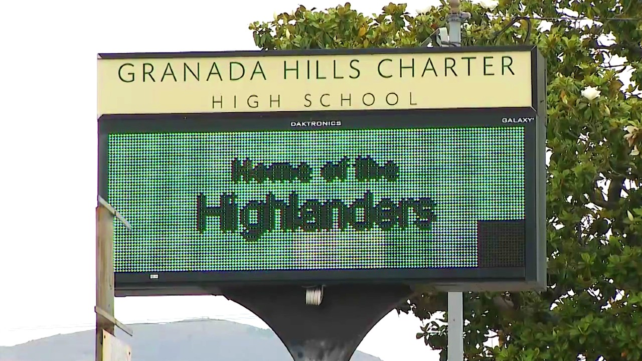 A sign is seen outside Granada Hills Charter High School. (KTLA)