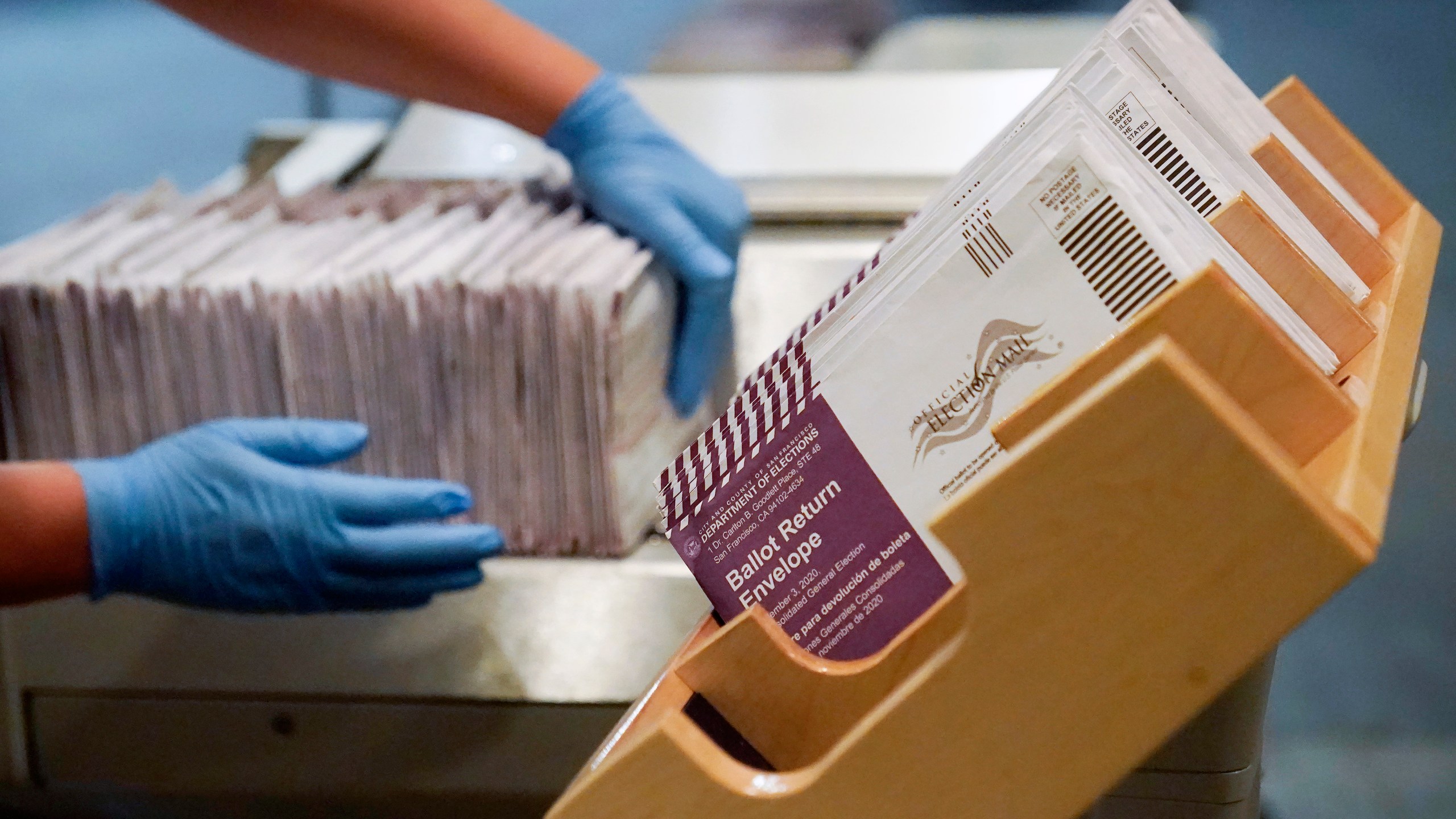 In this Nov. 1, 2020, file photo, envelopes containing ballots are shown at a San Francisco Department of Elections at a voting center in San Francisco. A new study finds the expansion of mail voting did not benefit Democrats or increase turnout. (AP Photo/Jeff Chiu, File)