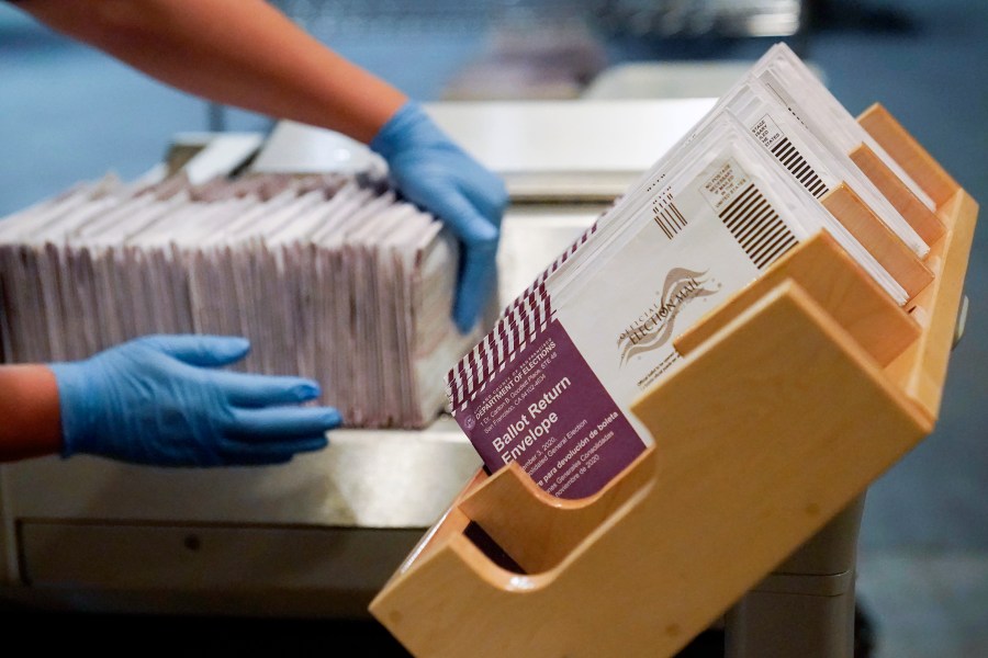 In this Nov. 1, 2020, file photo, envelopes containing ballots are shown at a San Francisco Department of Elections at a voting center in San Francisco. A new study finds the expansion of mail voting did not benefit Democrats or increase turnout. (AP Photo/Jeff Chiu, File)