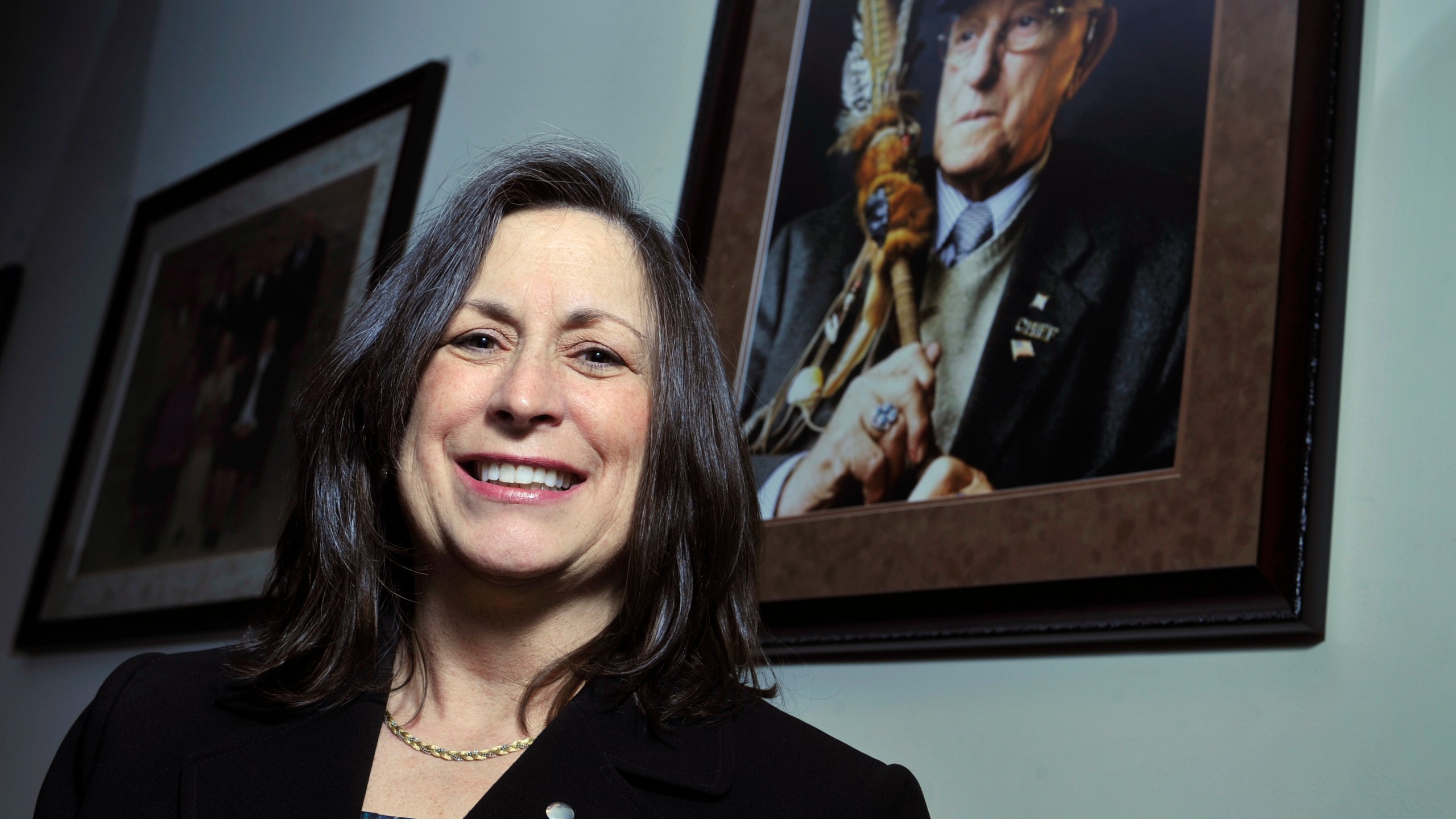 Marilynn "Lynn" Malerba stands next to a photograph of late Chief Ralph Sturges at Tribal offices in Uncasville, Conn., on March 4, 2010. Malerba, who is Native American, was nominated to be U.S. Treasurer in a historic first on June 21, 2022. (Jessica Hill/Associated Press)