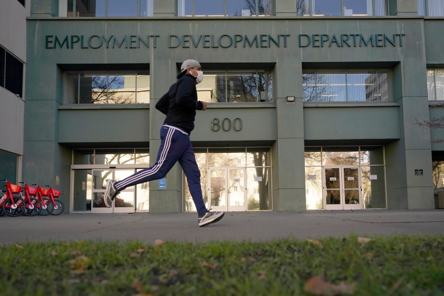 A runner passes the office of the California Employment Development Department in Sacramento, Calif., on Dec. 18, 2020. (Rich Pedroncelli/Associated Press)