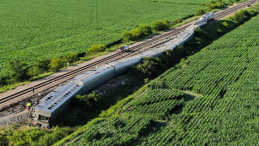 An Amtrak train lies derailed after the train hit a truck at a crossing near Mendon, Mo. on June 27, 2022. (Jill Toyoshiba/The Kansas City Star via AP)