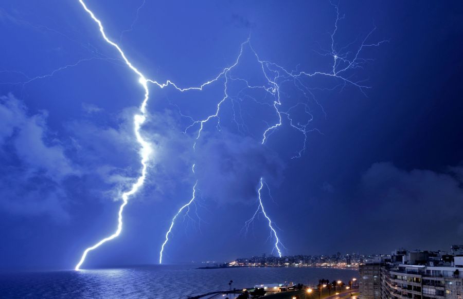 Lightning strikes during a thunderstorm in Montevideo on February 20, 2022. (Photo by Mariana SUAREZ / AFP)