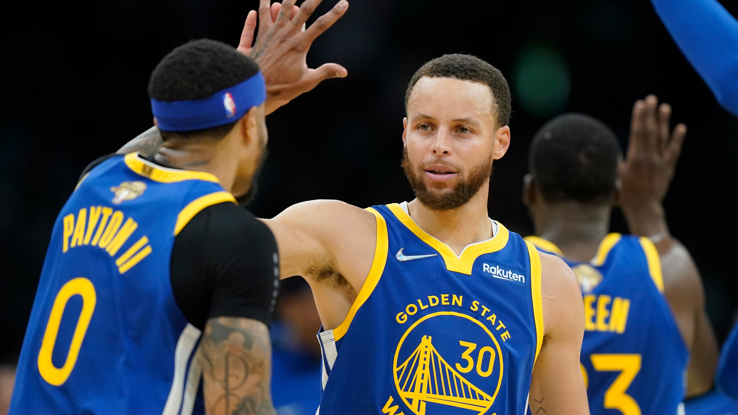 Golden State Warriors guard Stephen Curry (30) high fives Golden State Warriors guard Gary Payton II (0) during the second quarter of Game 6 of basketball's NBA Finals against the Boston Celtics, Thursday, June 16, 2022, in Boston. (AP Photo/Steven Senne)