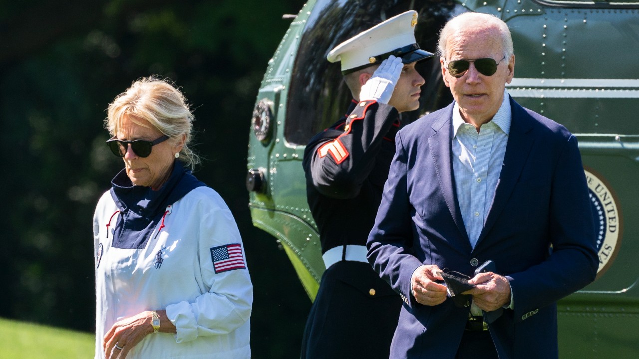 President Joe Biden and first lady Jill Biden walk on the South Lawn upon arrival at the White House from Rehoboth Beach, Del., Sunday, June 5, 2022, in Washington. (AP Photo/Manuel Balce Ceneta)