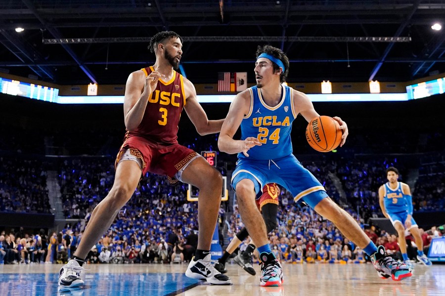 UCLA guard Jaime Jaquez Jr., right, tries to get by Southern California forward Isaiah Mobley during the second half of an NCAA college basketball game on March 5, 2022, in Los Angeles. UCLA and Southern California are planning to leave the Pac-12 for the Big Ten Conference in a seismic change that could lead to another major realignment of college sports. (AP Photo/Mark J. Terrill, File)