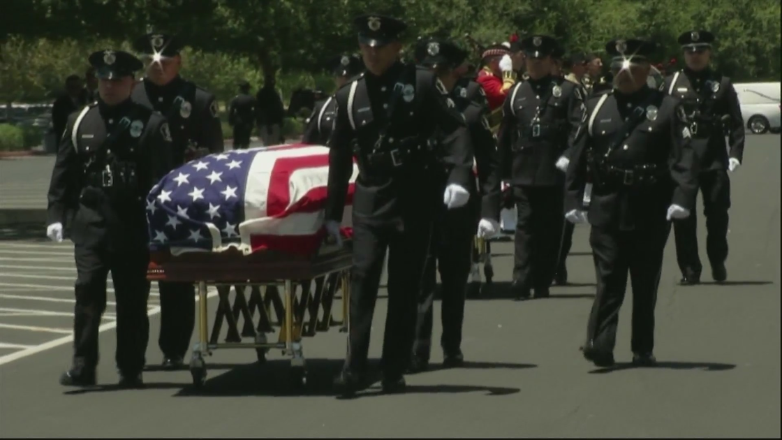 The caskets of two fallen El Monte police officers are carried away following a memorial service in Ontario on June 30, 2022. (Pool)