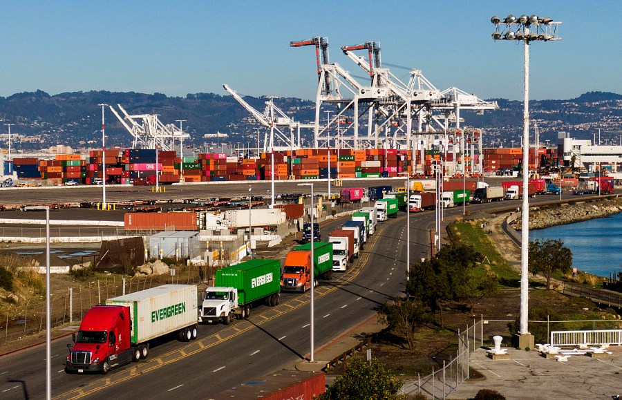 Trucks line up to enter a Port of Oakland shipping terminal on Nov. 10, 2021, in Oakland, Calif. Truckers protesting a state labor law have effectively shut down cargo operations at the Port of Oakland, it was announced Wednesday, July 20, 2022. The protest that began Monday, July 18 involves hundreds of independent big-rig truckers that have blocked the movement of cargo in and out of terminals at the port, which is one of the 10 busiest container ports in the country. (AP Photo/Noah Berger, File)