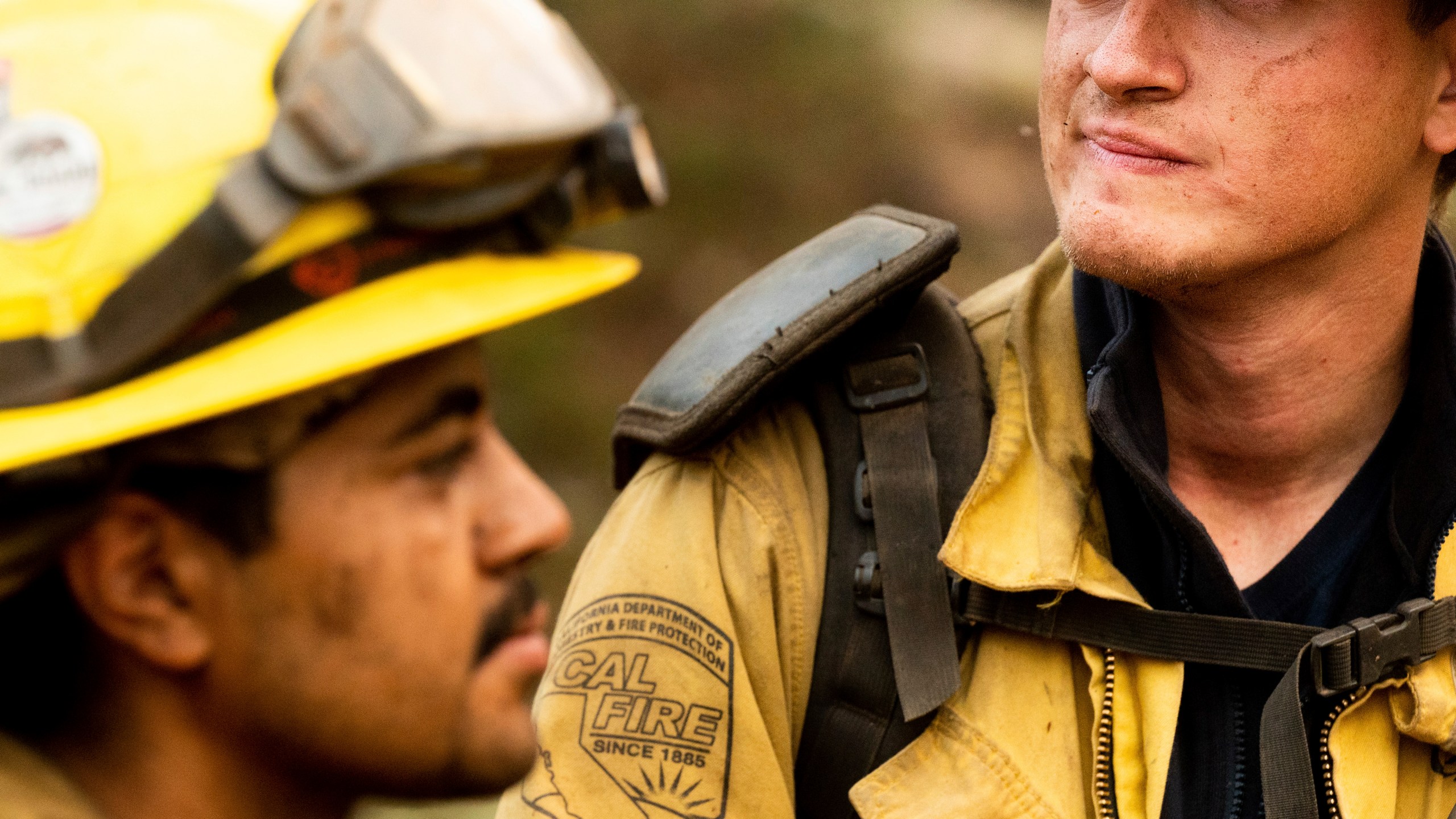 Firefighters Jerome Alton, right, and Sergio Porras wrap up an overnight shift battling the Oak Fire in the Jerseydale community of Mariposa County, Calif., on Monday, July 25, 2022. (AP Photo/Noah Berger)