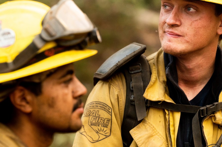 Firefighters Jerome Alton, right, and Sergio Porras wrap up an overnight shift battling the Oak Fire in the Jerseydale community of Mariposa County, Calif., on Monday, July 25, 2022. (AP Photo/Noah Berger)