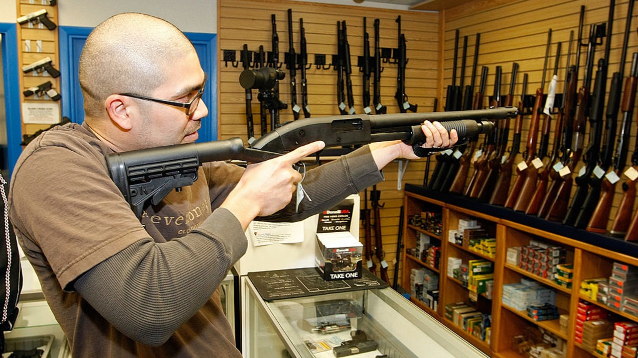 Anthony Del Rosario of Nevada examines a shotgun at The Gun Store November 14, 2008 in Las Vegas, Nevada. (Photo by Ethan Miller/Getty Images)