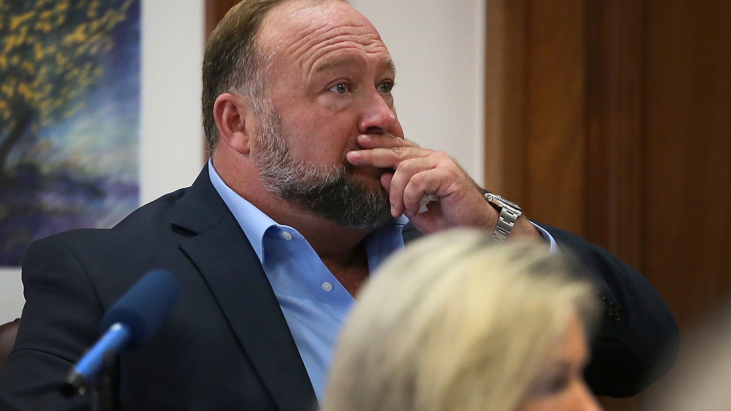 Alex Jones attempts to answer questions about his text messages asked by Mark Bankston, lawyer for Neil Heslin and Scarlett Lewis, during trial at the Travis County Courthouse in Austin on Aug. 3, 2022.(Briana Sanchez/Austin American-Statesman via AP, Pool)