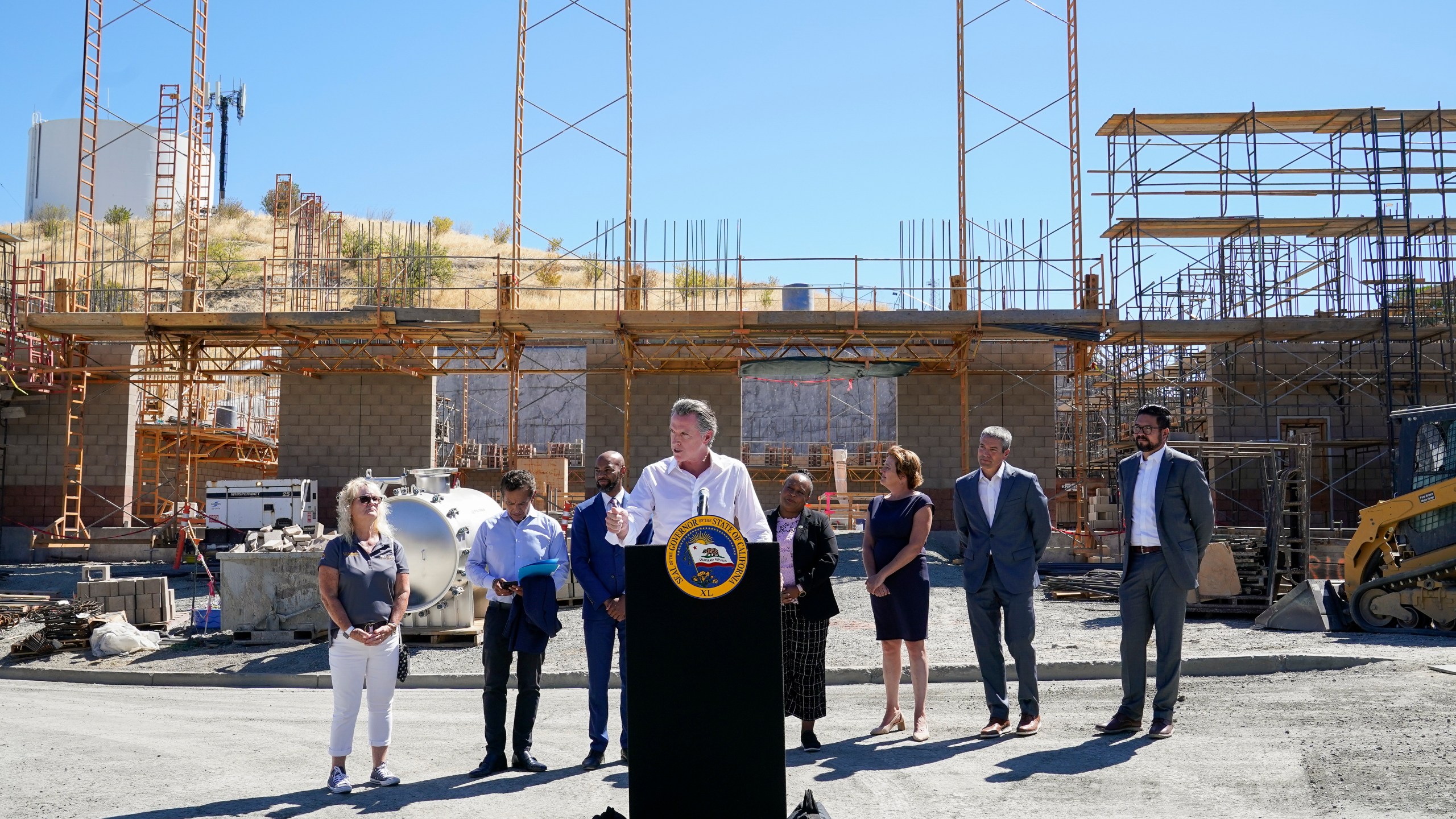 Gov. Gavin Newsom, center, talks to reporters during a press conference at the construction site of a water desalination plant in Antioch, Calif., Thursday, Aug. 11, 2022. (AP Photo/Godofredo A. Vásquez)