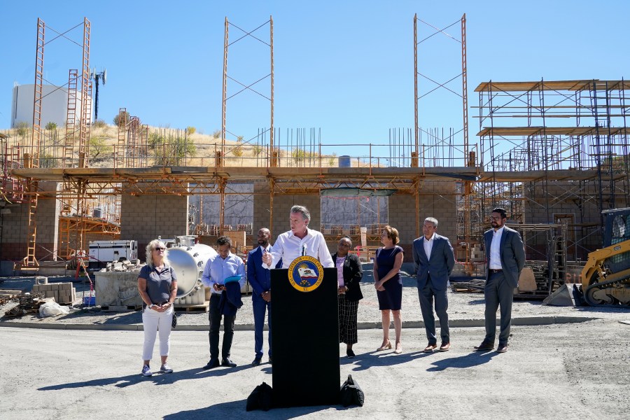 Gov. Gavin Newsom, center, talks to reporters during a press conference at the construction site of a water desalination plant in Antioch, Calif., Thursday, Aug. 11, 2022. (AP Photo/Godofredo A. Vásquez)