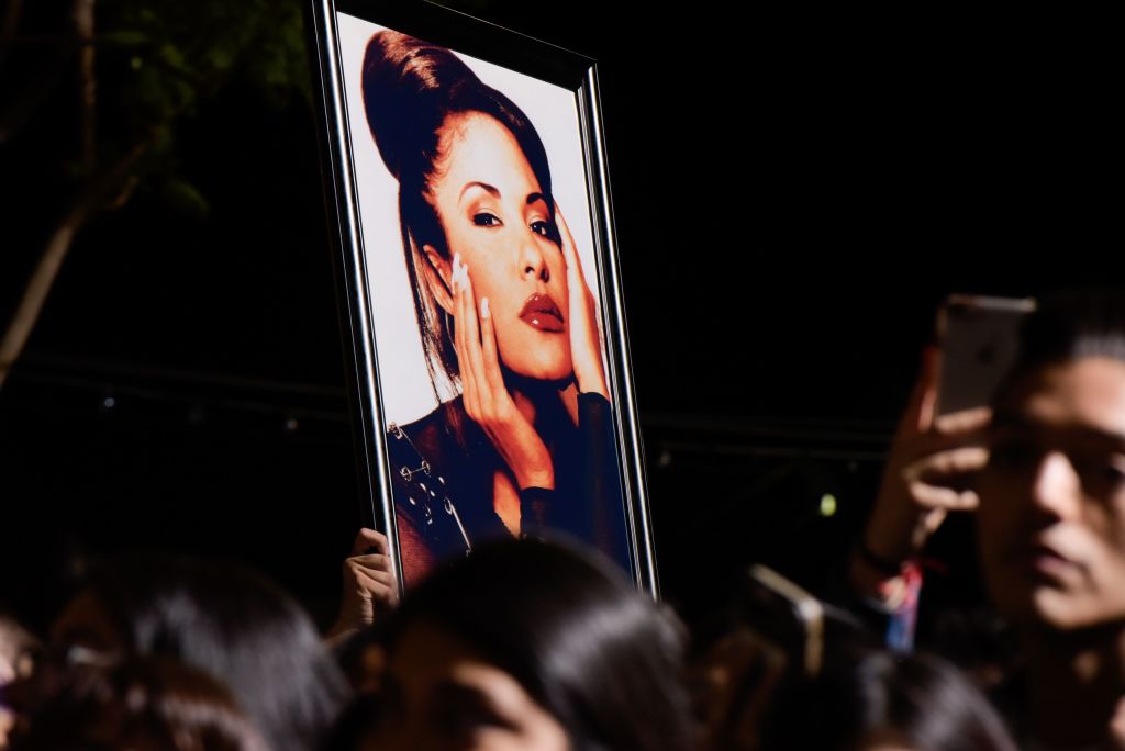 Fans hold a photo of Selena during the ceremony honoring singer Selena Quintanilla with a Star on the Hollywood Walk of Fame on November 3, 2017, in Hollywood. (TARA ZIEMBA/AFP via Getty Images)