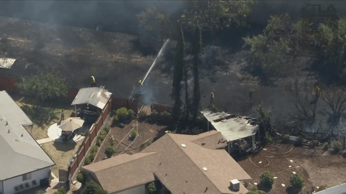 Crews were battling a small brush fire that was threatening homes in Pacoima on Aug. 17, 2022. (KTLA)