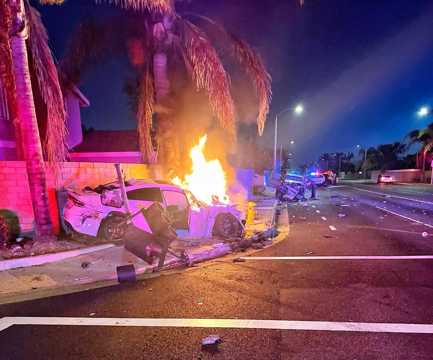 A Dodge Charger is engulfed following a crash in Huntington Beach on Saturday, Aug. 6, 2022 (Huntington Beach Police Department)