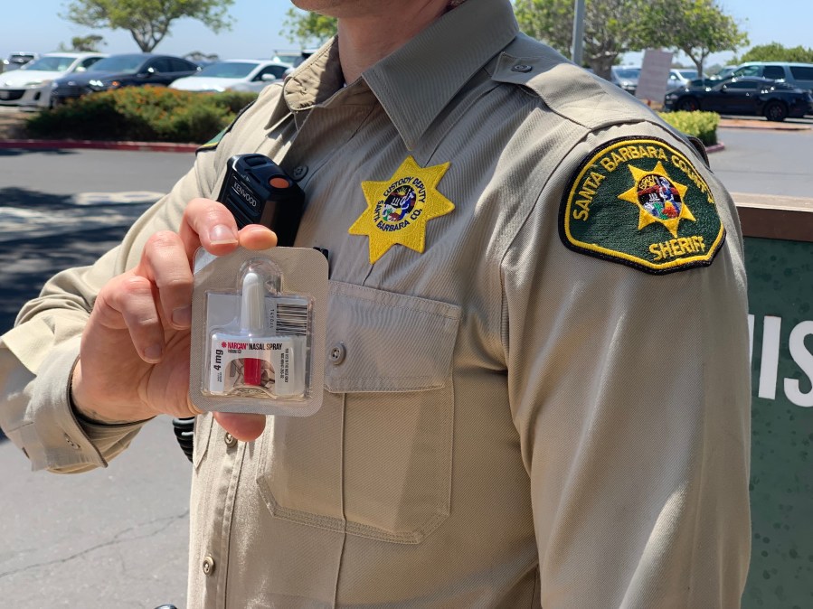 Deputy holding Narcan, a nasal spray overdose treatment, after an apparent overdose at the Santa Barbara County Jail