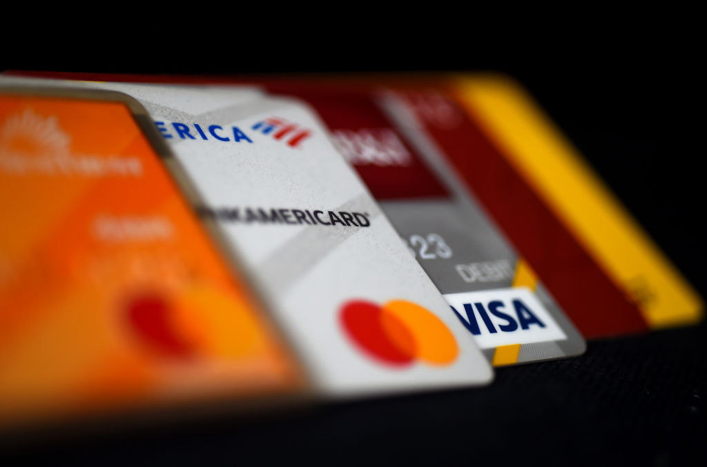 Debit and credit cards arranged on a desk