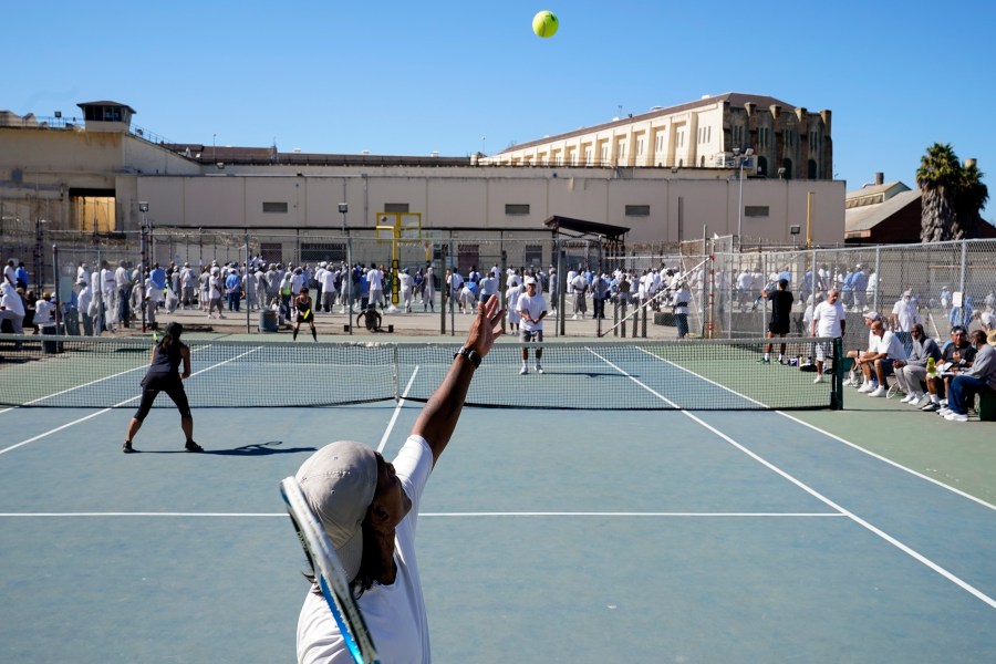 James Duff, bottom, serves during a tennis match between fellow San Quentin State Prison inmates and visiting players in San Quentin, Calif., Saturday, Aug. 13, 2022. (AP Photo/Godofredo A. Vásquez)