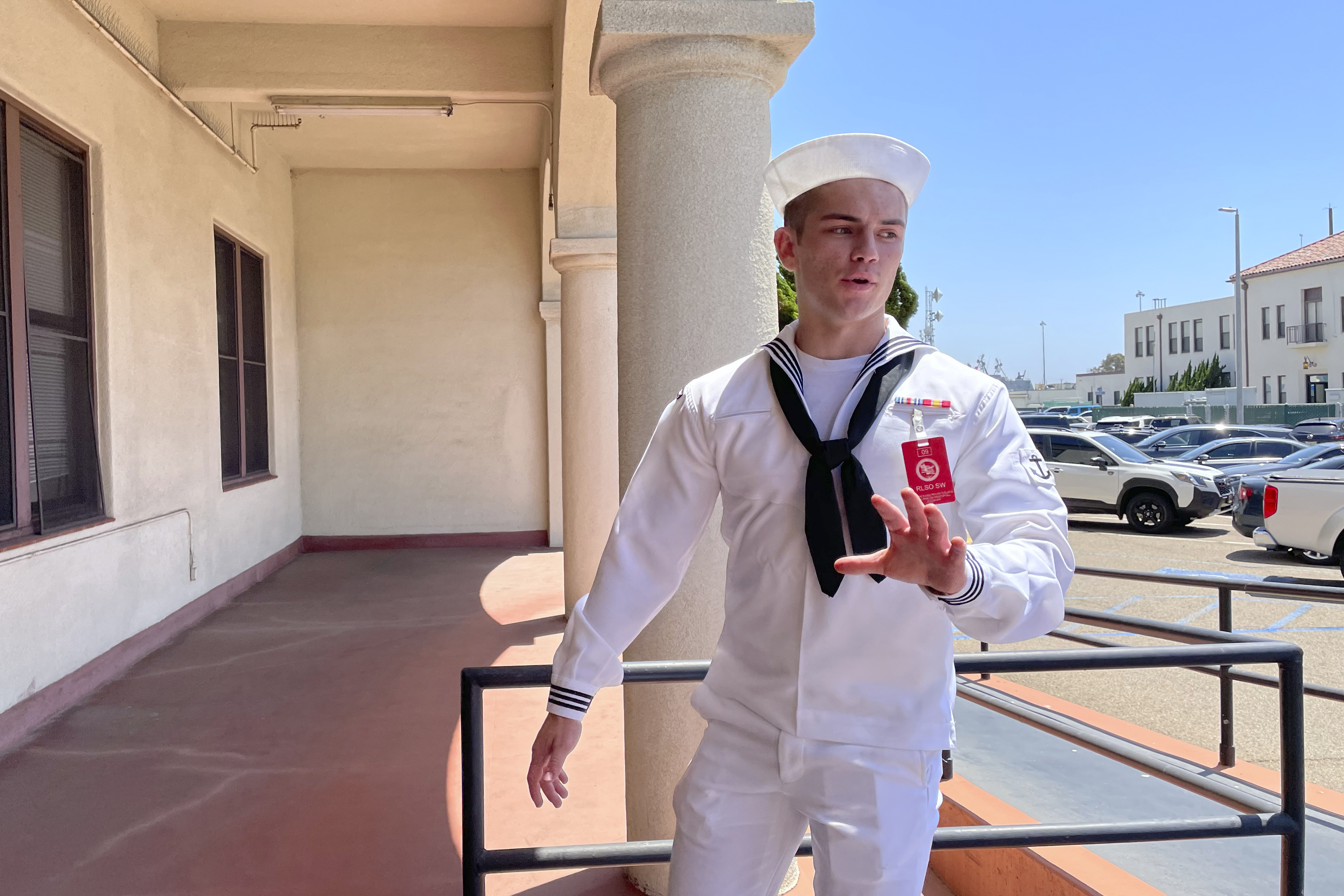 U.S. Navy sailor Ryan Sawyer Mays walks past reporters at Naval Base San Diego before entering a Navy courtroom Wednesday, Aug. 17, 2022, in San Diego. Mays is accused of setting the USS Bonhomme Richard on fire, and his court martial is scheduled to begin Monday, Sept. 19, 2022. The July 2020 blaze damaged the billion-dollar warship so badly it had to be scuttled and marked one of the worst noncombat US warship disasters in recent memory. (AP Photo/Julie Watson)