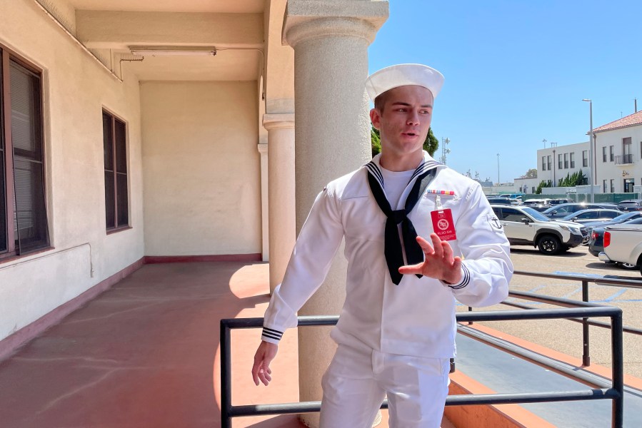 U.S. Navy sailor Ryan Sawyer Mays walks past reporters at Naval Base San Diego before entering a Navy courtroom Wednesday, Aug. 17, 2022, in San Diego. Mays is accused of setting the USS Bonhomme Richard on fire, and his court martial is scheduled to begin Monday, Sept. 19, 2022. The July 2020 blaze damaged the billion-dollar warship so badly it had to be scuttled and marked one of the worst noncombat US warship disasters in recent memory. (AP Photo/Julie Watson)