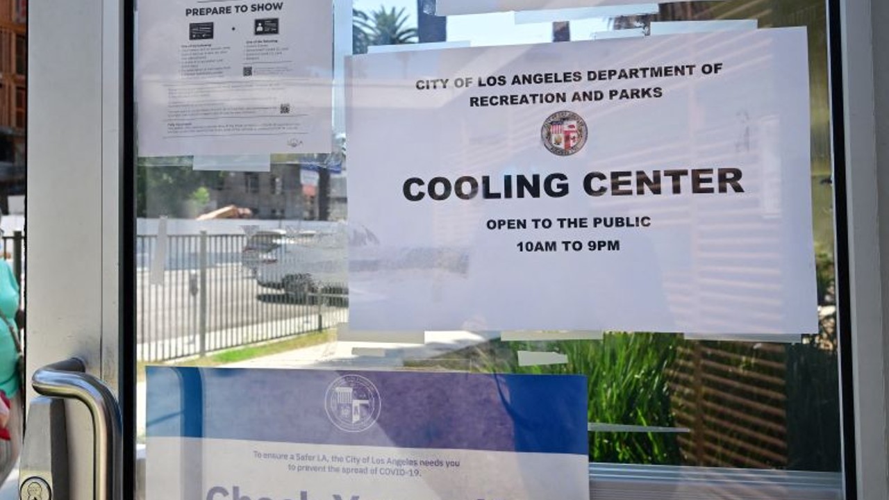 People make their way out of the heat into a cooling center in Los Angeles, California, on September 2, 2022. (Photo by FREDERIC J. BROWN/AFP via Getty Images)