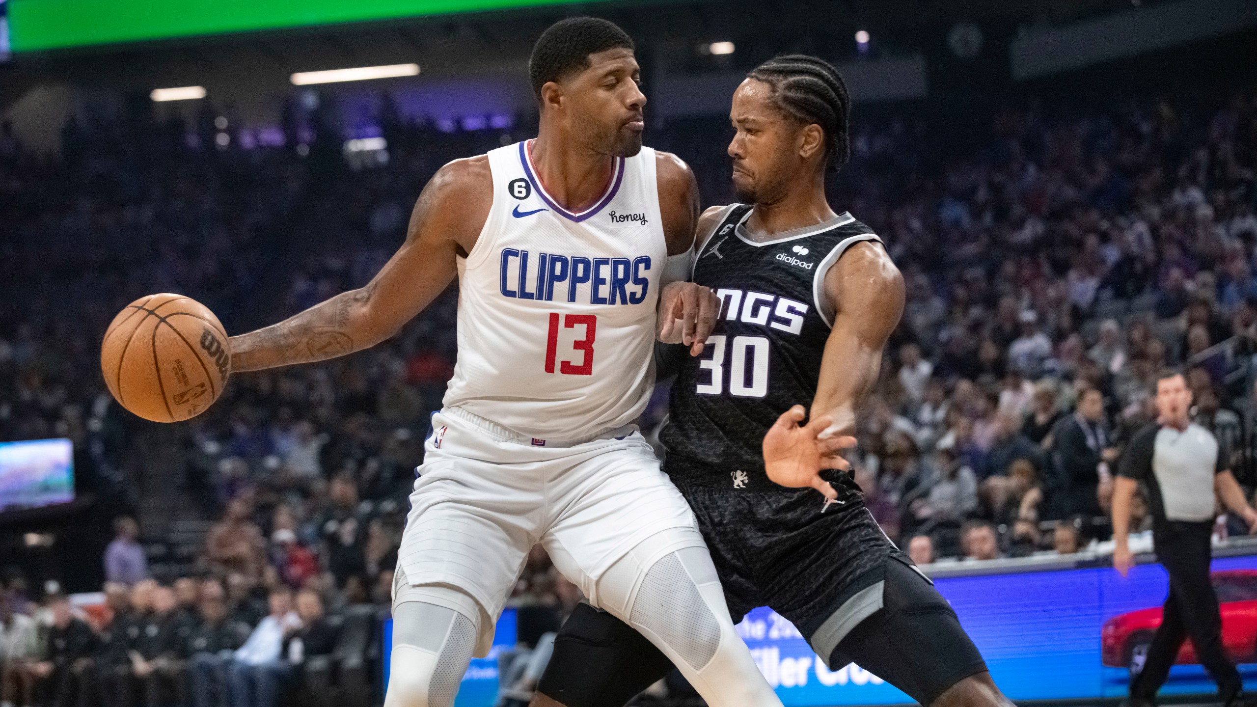 Los Angeles Clippers guard Paul George is guarded by Sacramento Kings forward KZ Okpala during the first quarter of an NBA basketball game in Sacramento on Saturday, Oct. 22, 2022. (AP Photo/Randall Benton)