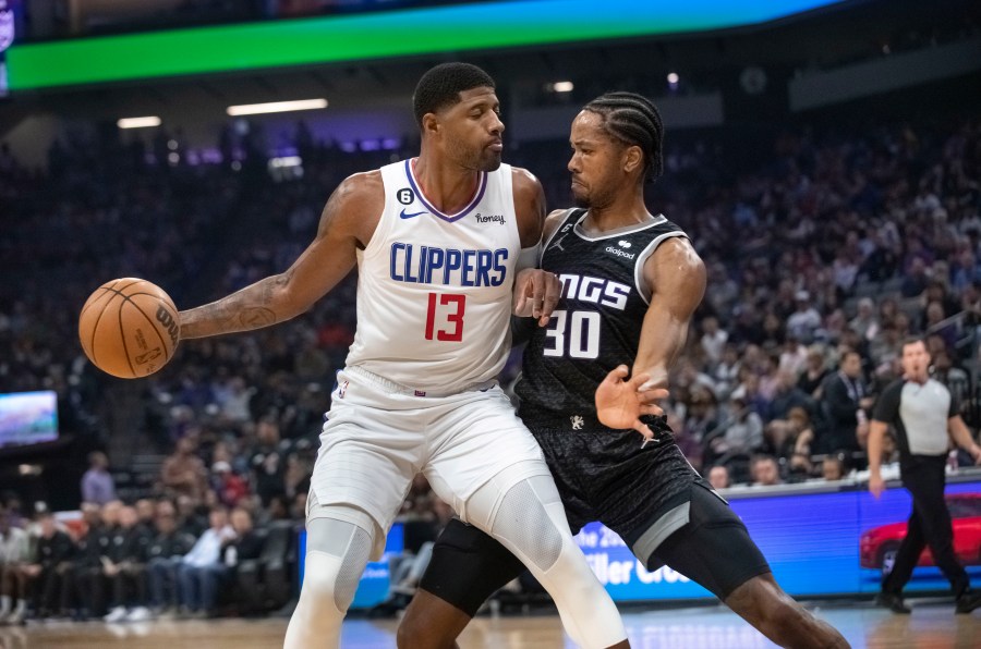 Los Angeles Clippers guard Paul George is guarded by Sacramento Kings forward KZ Okpala during the first quarter of an NBA basketball game in Sacramento on Saturday, Oct. 22, 2022. (AP Photo/Randall Benton)