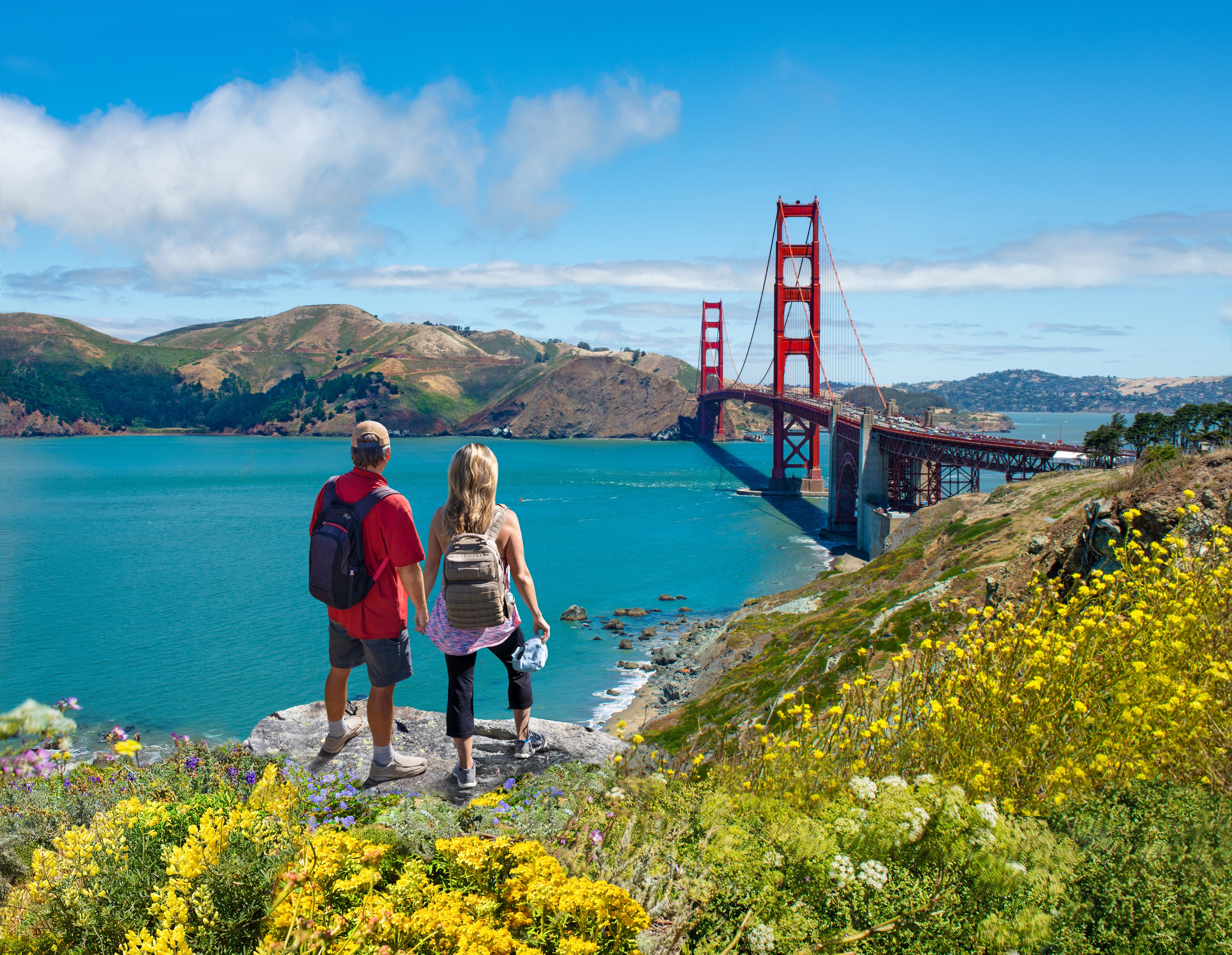 Couple enjoying beautiful coastal scenery on summer vacation. People on vacation in San Francisco. Golden Gate Bridge, San Francisco Bay,