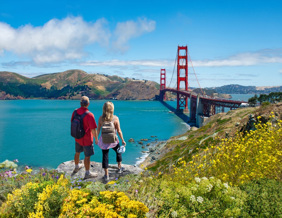 Couple enjoying beautiful coastal scenery on summer vacation. People on vacation in San Francisco. Golden Gate Bridge, San Francisco Bay,