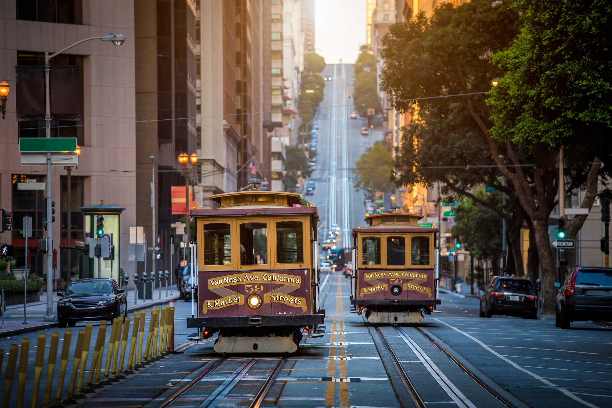 Classic view of historic traditional Cable Cars riding on famous California Street in beautiful early morning light at sunrise in summer, San Francisco, California. (Getty)