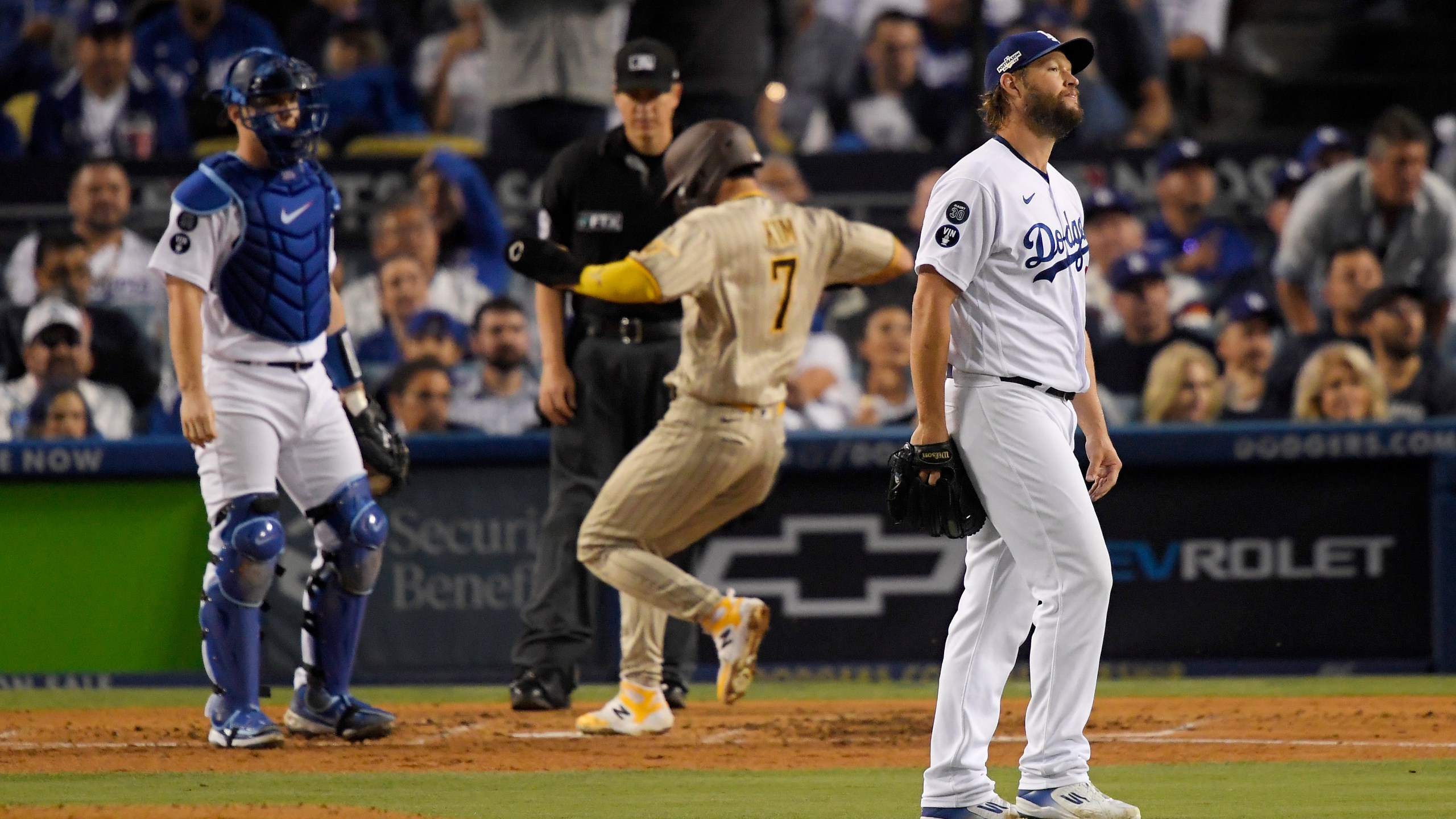 Clayton Kershaw of the Los Angeles Dodgers reacts after Ha-Seong Kim of the San Diego Padres scores on an RBI double by Manny Machado in the third inning in Game 2 of the National League Division Series at Dodger Stadium on Oct. 12, 2022, in Los Angeles, California. (Kevork Djansezian/Getty Images)