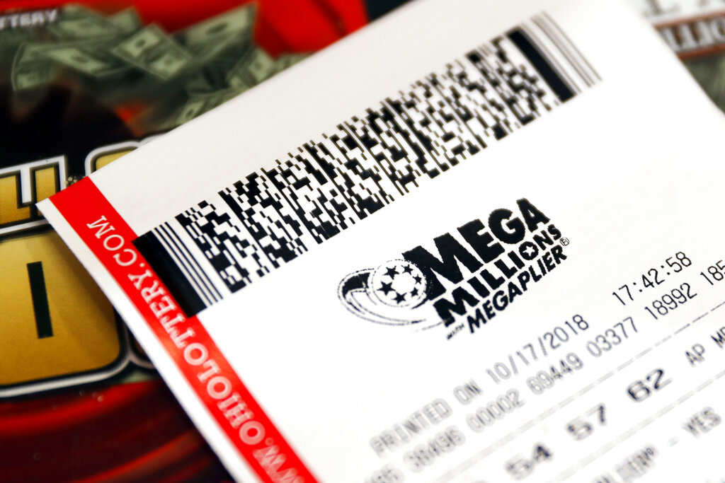 In this file photo, a Mega Millions lottery ticket rests on the shop counter at the Street Corner Market in Cincinnati. (John Minchillo/Associated Press)