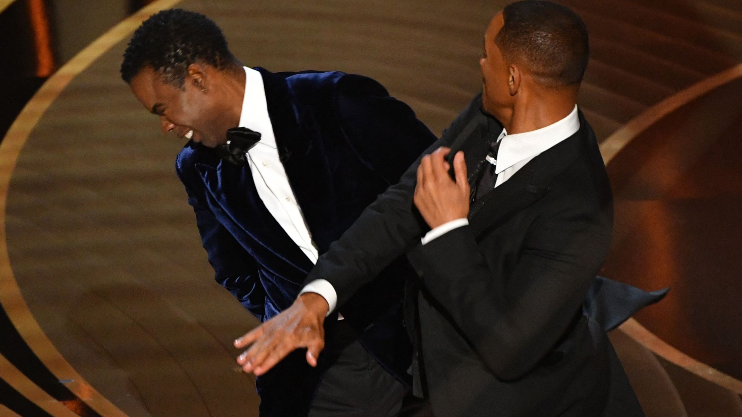 Will Smith, right, slaps Chris Rock onstage during the 94th Oscars at the Dolby Theatre in Hollywood, California, on March 27, 2022. (Robyn Beck / AFP via Getty Images)