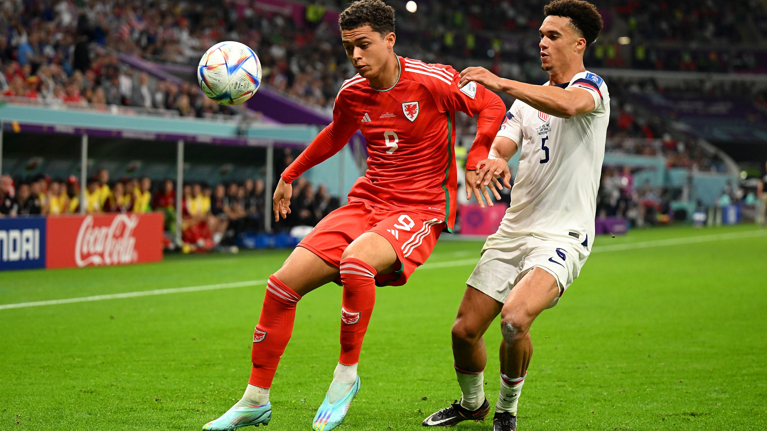 Brennan Johnson of Wales controls the ball under pressure of Antonee Robinson of United States during the FIFA World Cup Qatar 2022 Group B match between USA and Wales at Ahmad Bin Ali Stadium on Nov. 21, 2022 in Doha, Qatar. (Clive Mason/Getty Images)