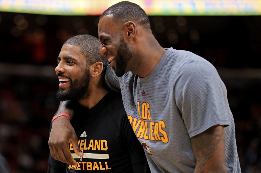 Kyrie Irving and LeBron James, then of the Cleveland Cavaliers, laugh during a game against the Miami Heat at American Airlines Arena on March 4, 2017, in Miami, Florida. (Mike Ehrmann/Getty Images)