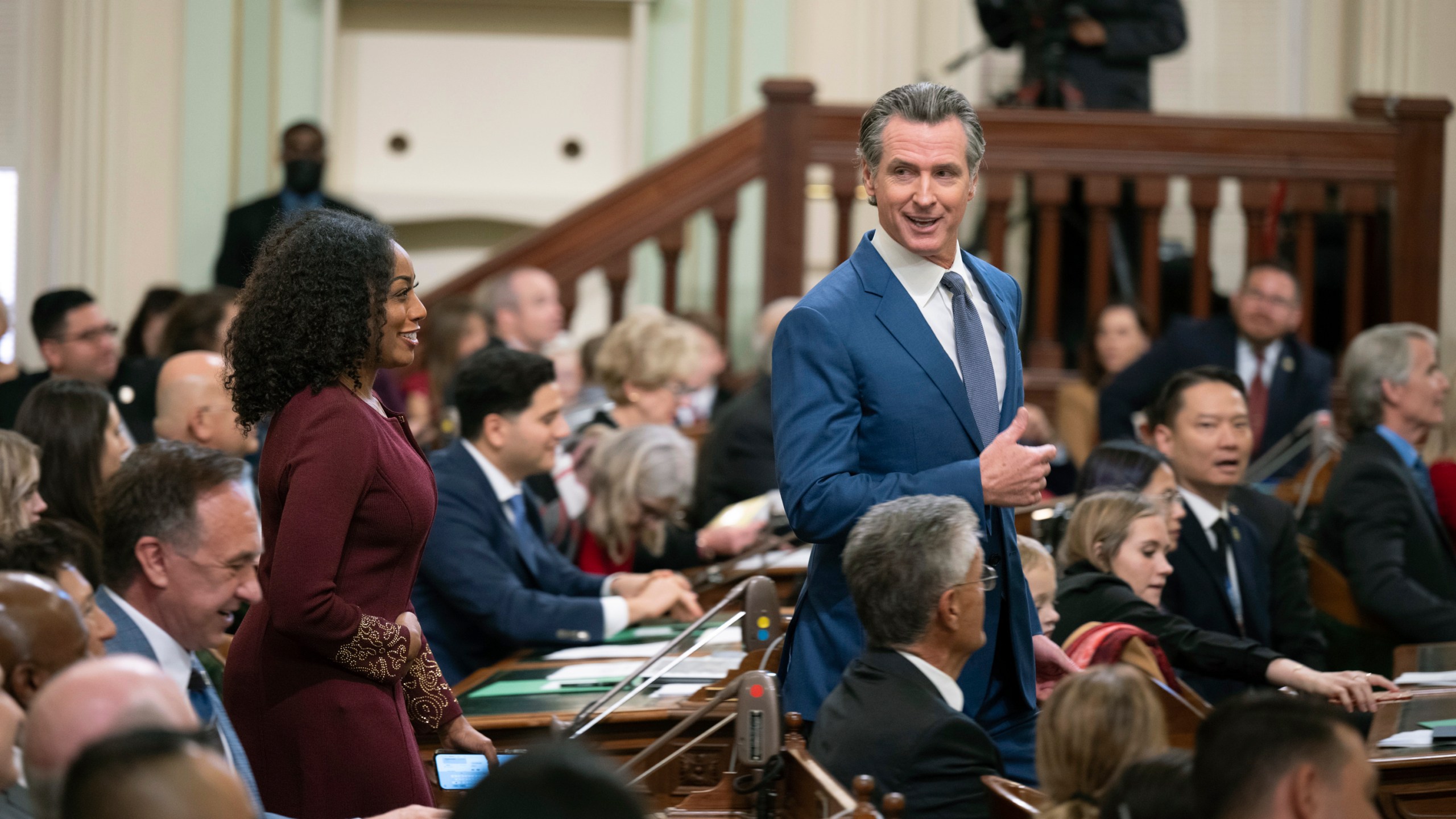 California Gov. Gavin Newsom walks through the assembly chamber with California Controller Malia Cohen during the opening session of the California Legislature in Sacramento, Calif., Monday, Dec. 5, 2022. The legislature returned to work on Monday to swear in new members and elect leaders for the upcoming session. (AP Photo/José Luis Villegas, Pool)