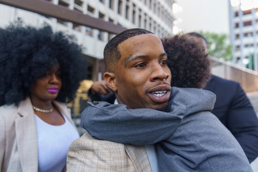 Rapper Tory Lanez, 30, walks out of a Los Angeles courthouse while holding his 5-year-old son Kai'Lon on Dec. 13, 2022. (Damian Dovarganes/Associated Press)