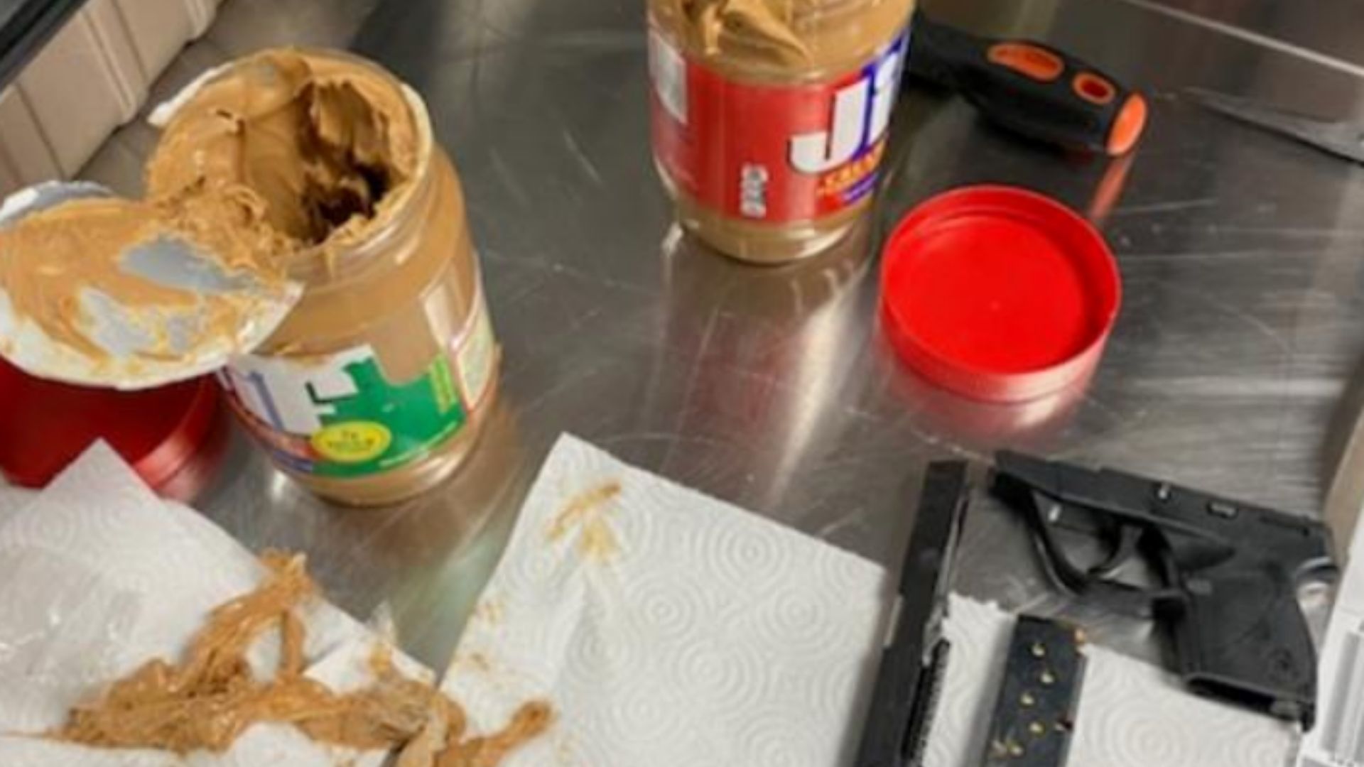 A man tried to hide gun parts and a loaded magazine inside jars of peanut butter as he passed through a TSA checkpoint at JFK Airport on Dec. 22, 2022, officials said. (TSA)