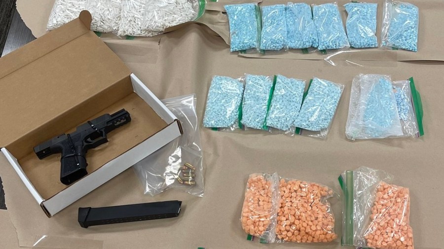 Drugs and a handgun seized by a special investigations unit is seen in an image provided by the Newport Beach Police Department on Dec. 15, 2022.