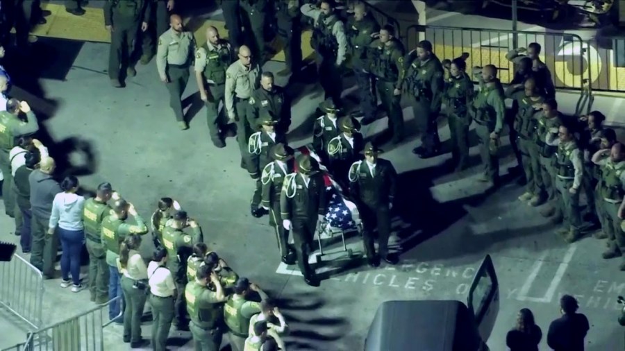 Law enforcement officers gather around at Riverside Community Hospital for a procession of a fallen Riverside County Sheriff's Deputy who was shot and killed Dec. 29, 2022