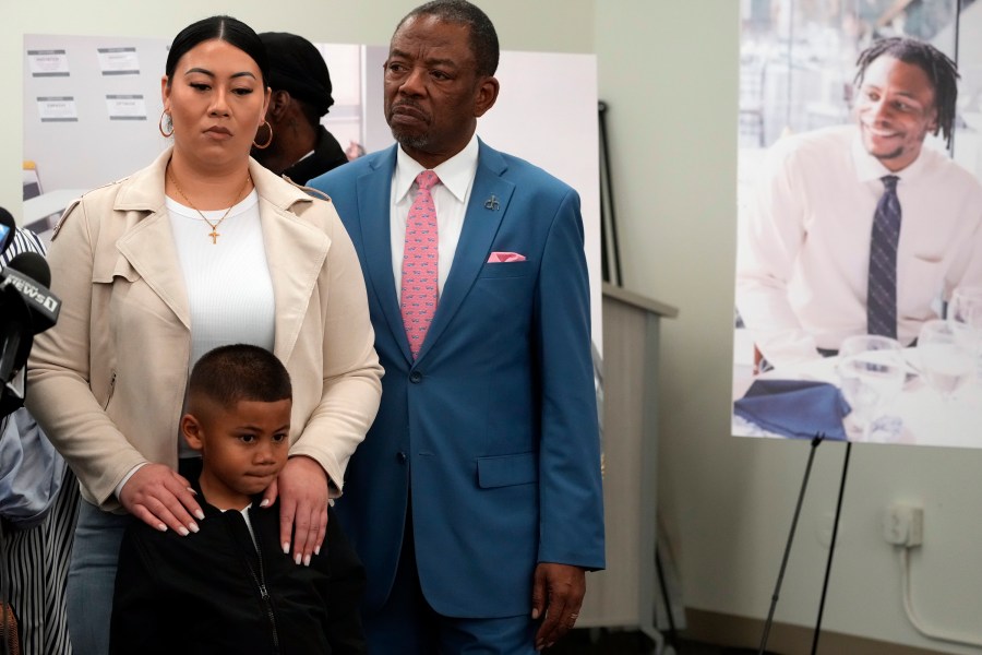 Lawyer Carl Douglas, right, holds a news conference with Gabrielle Hansel, guardian of 5-year-old Syncere Kai Anderson, to announce filing a $50 million in damages claim against the city of Los Angeles over the death of Keenan Anderson, seen photo right, at a news conference in Los Angeles Friday, Jan. 20, 2023. (AP Photo/Damian Dovarganes)