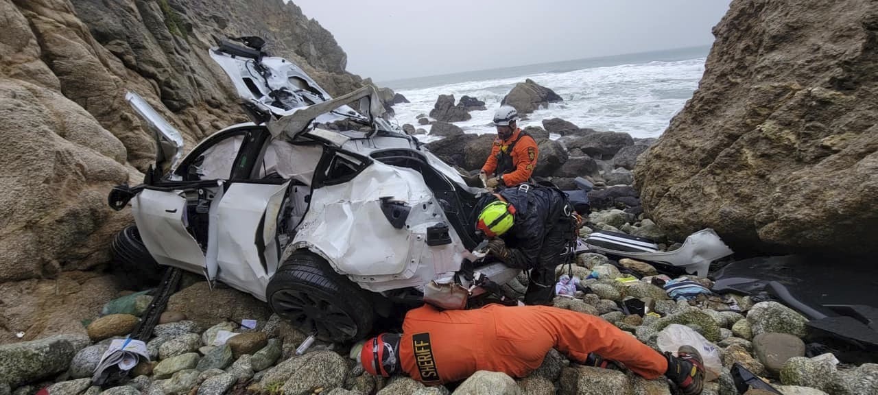 This photo provided by the San Mateo County Sheriff's Office shows emergency personnel responding to a vehicle over the side of Highway 1 on Jan. 1, 2023, in San Mateo County. (Sgt. Brian Moore/San Mateo County Sheriff's Office via AP