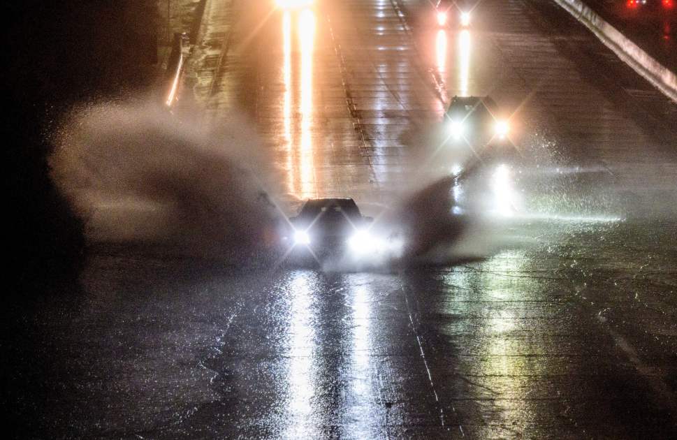 Drivers barrel into standing water on Interstate 101 in San Francisco on Jan. 4, 2023. A bomb cyclone smashed into California on Wednesday bringing powerful winds and torrential rain that was expected to cause flooding in areas already saturated by consecutive storms. (Josh Edelson/AFP via Getty Images)