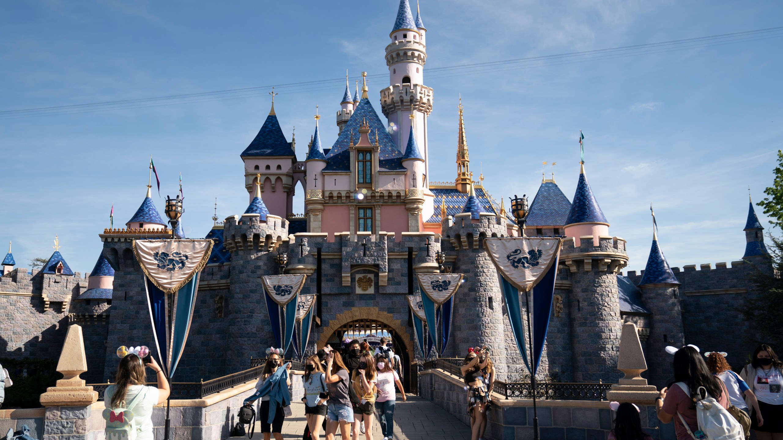 Visitors pass through Disneyland in Anaheim, Calif., on April 30, 2021. A lawsuit claims Disneyland employees snickered at Joanne Aguilar, 66, a disabled woman struggling to get off a Jungle Cruise boat, before she fell and broke a leg on Aug. 22, 2021, leading to her death from an infection five months later. (AP Photo/Jae C. Hong, File)